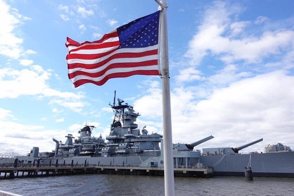 USS New Jersey and American flag